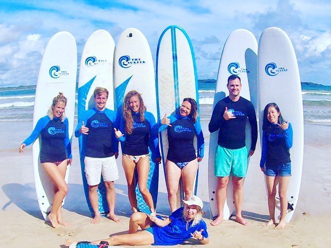 A group of surfers with their boards on the beach